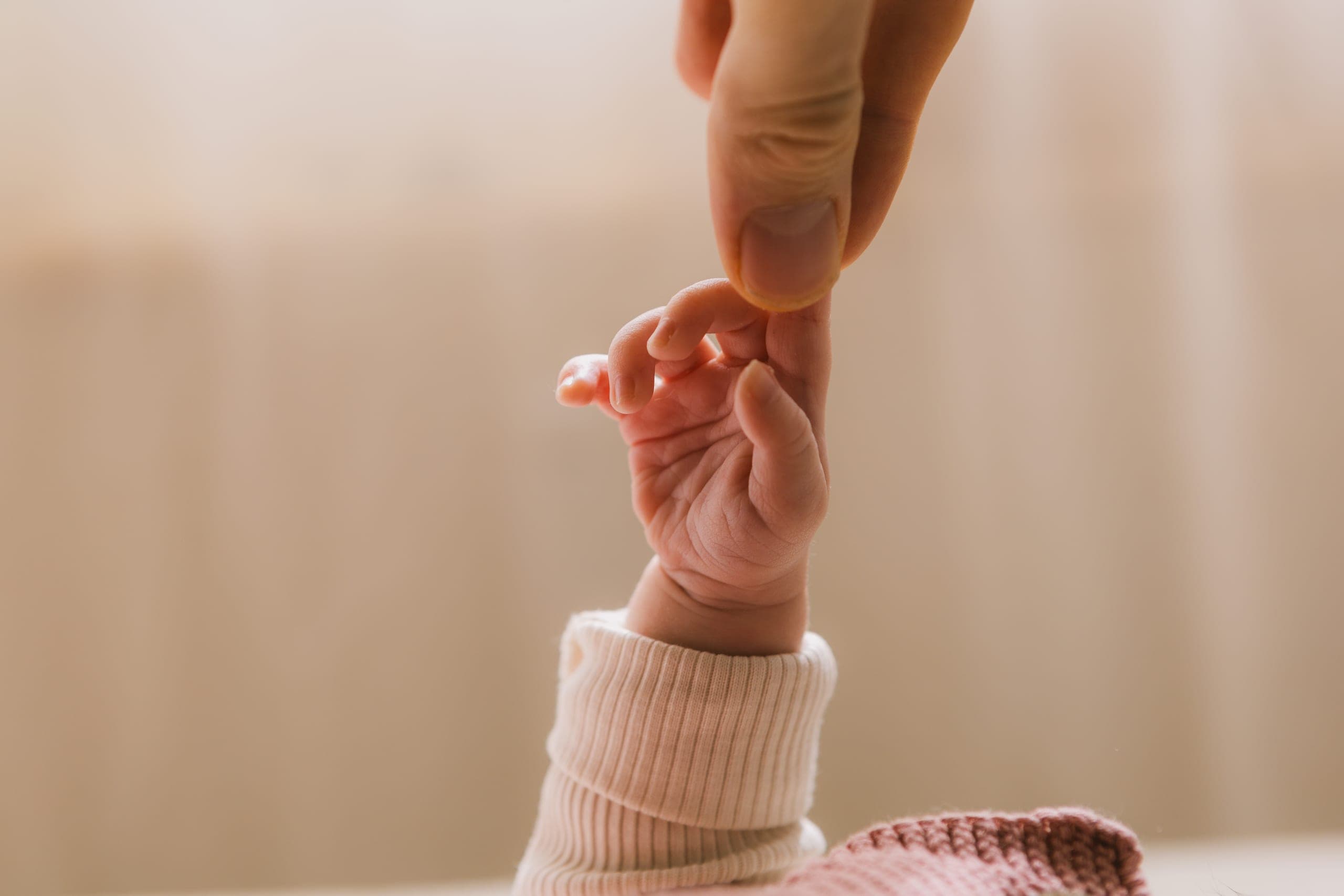 Babyhand berührt Papas Finger
